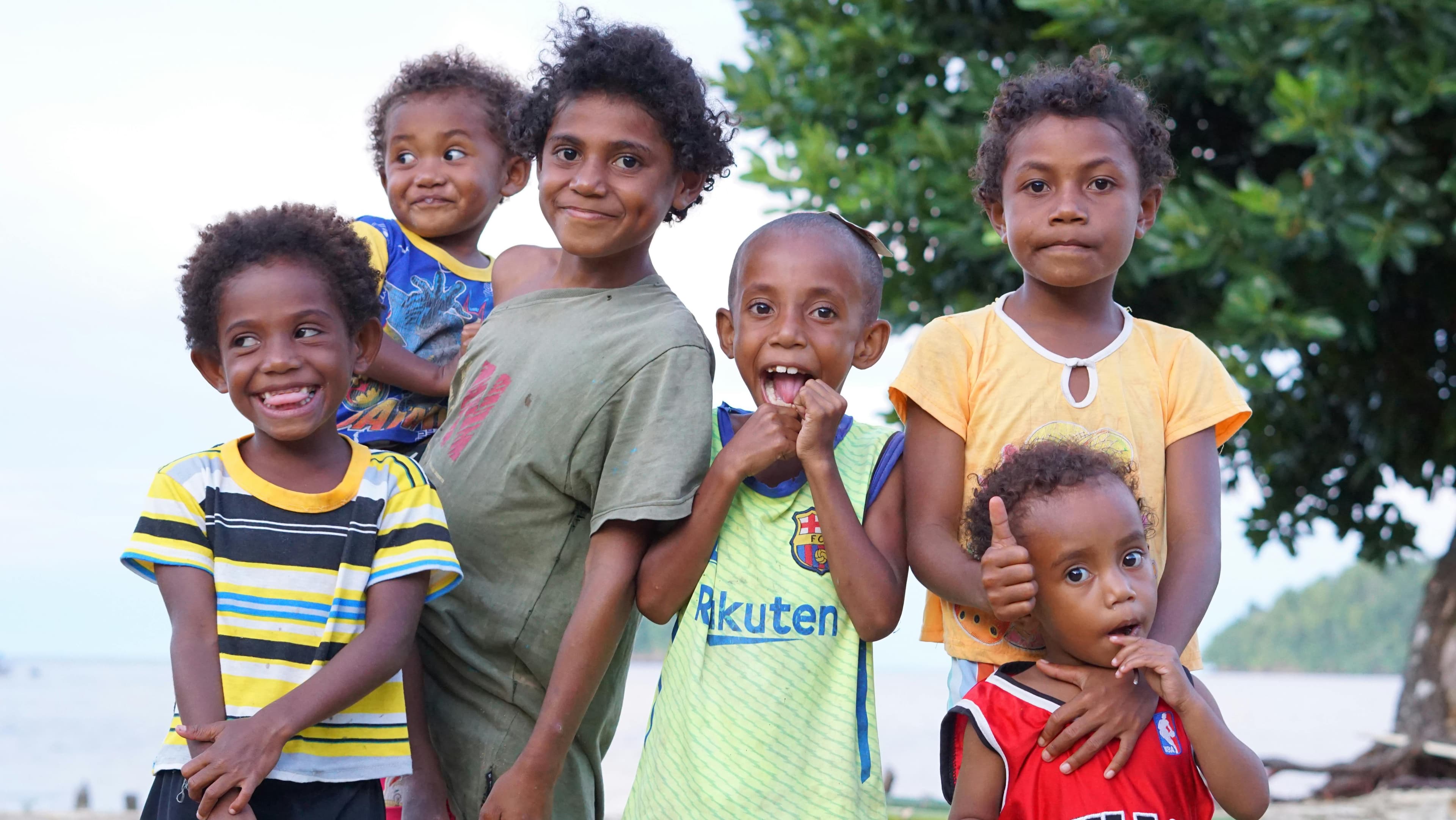 A small group standing near supplies and boxes in a community setting.