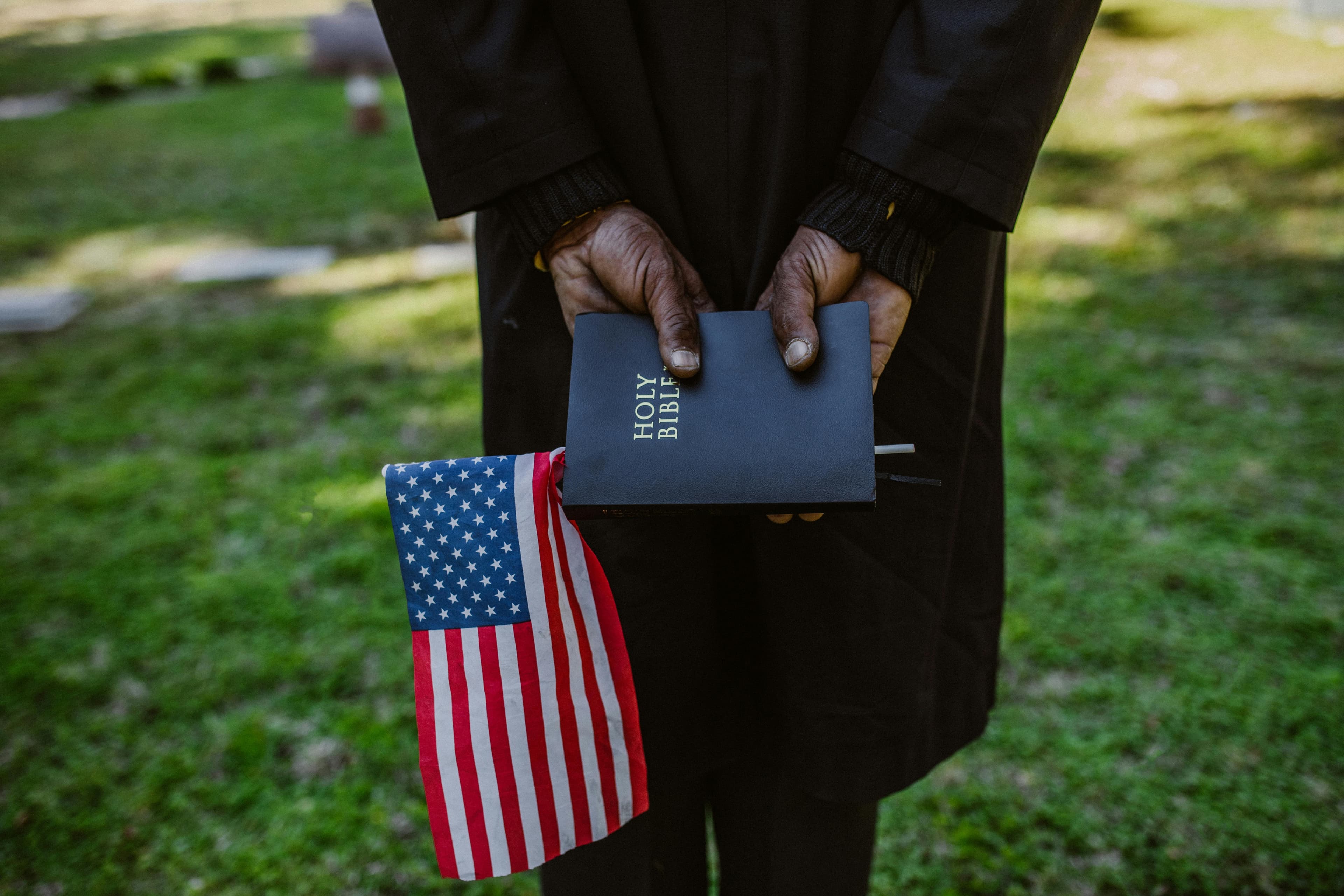 An American flag folded beside a Bible.